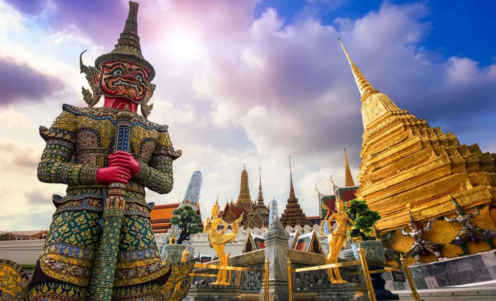 Bangkok — gilded chedis of Wat Pho rising above the old city rooftops